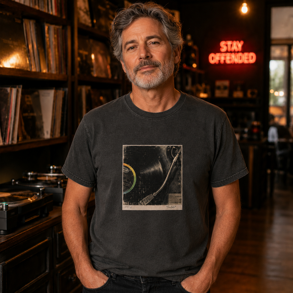 Man wearing the Turntable original art T-shirt in a Stay Offended record shop